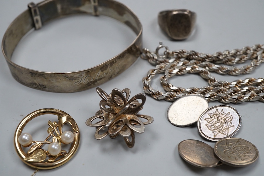 A collection of silver jewels, comprising: a bangle; a chain necklace suspending two winding toothpicks, one with toothpick deficient; a rope twist chain; a pair of cufflinks with the initials DBH; a pendant of abstract